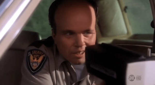 Clint Howard as a policeman