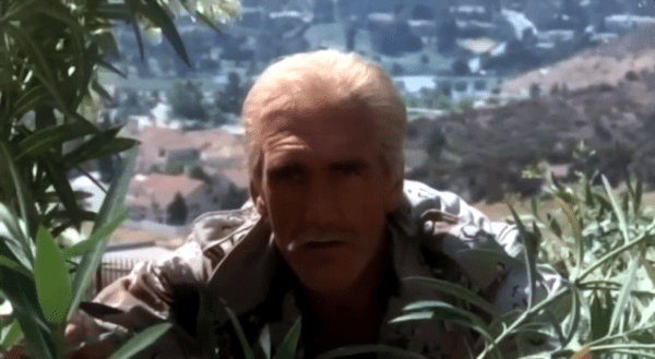 Hulk Hogan with hair hiding in the bushes